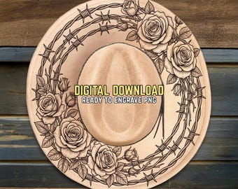 Puede incluir: Un sombrero de vaquero beige con un diseño decorativo de rosas y alambre de púas. El sombrero presenta el texto "DIGITAL DOWNLOAD READY TO ENGRAVE PNG". El sombrero está sobre un fondo de madera.