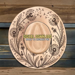 May include: A tan cowboy hat with a detailed black engraved design of dandelions and the text "DIGITAL DOWNLOAD READY TO ENGRAVE PNG". The hat has a rounded crown and a wide brim, perfect for laser engraving.