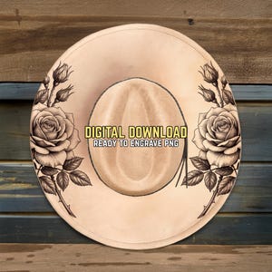 May include: A tan cowboy hat with a floral design. The hat features a large rose and rose buds on each side, with the text "DIGITAL DOWNLOAD READY TO ENGRAVE PNG" in the center.