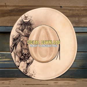 May include: A tan cowboy hat with a detailed illustration of a cowboy riding a horse. The hat has a wide brim and a rounded crown. Text on the hat reads "DIGITAL DOWNLOAD READY TO ENGRAVE PNG".