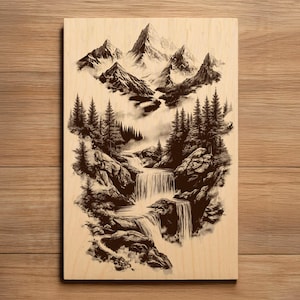 May include: A black and white mountain landscape art print on a wooden panel. The artwork depicts a waterfall cascading down rocks, surrounded by pine trees and mountains in the background. The art has a vintage, rustic feel.