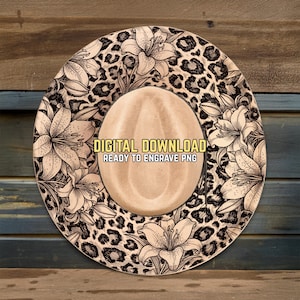 May include: A digitally designed cowboy hat with a beige crown and a wide brim. The brim features a leopard print pattern and floral illustrations. The text "DIGITAL DOWNLOAD READY TO ENGRAVE PNG" is printed on the crown.