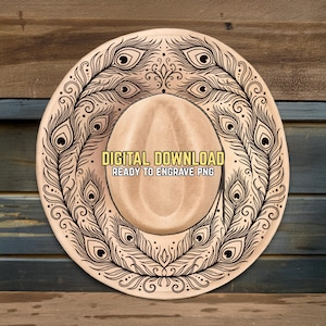 May include: A tan cowboy hat with a decorative black peacock feather design around the brim. The hat features the text "DIGITAL DOWNLOAD READY TO ENGRAVE PNG" in a yellow rectangle.