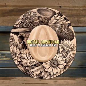 May include: A digitally designed cowboy hat with a detailed skull, floral, and feather motif. The hat features the text "DIGITAL DOWNLOAD READY TO ENGRAVE PNG". The hat is tan and the design is black and white.