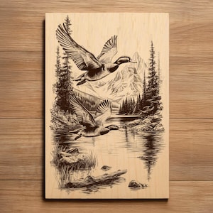 May include: A wood-burned artwork showing two ducks flying over a lake, with mountains and trees in the background. The piece is in shades of brown and black, creating a rustic, nature-inspired scene.