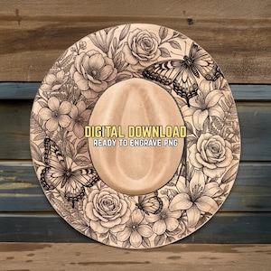 May include: A light brown cowboy hat with a floral and butterfly design. The hat features a detailed engraving of roses, lilies, and butterflies. The text "DIGITAL DOWNLOAD READY TO ENGRAVE PNG" is printed on the hat.