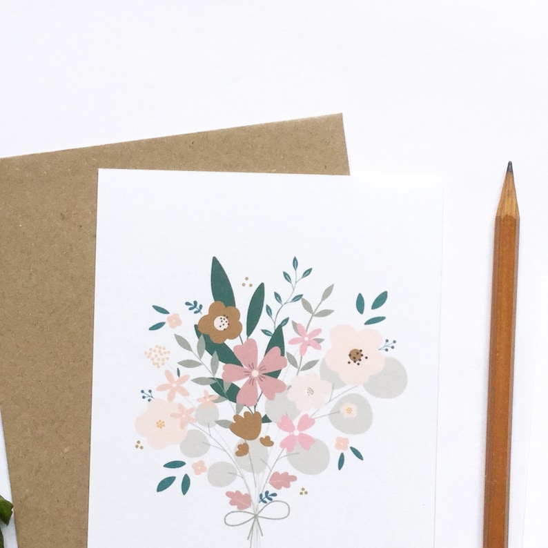 May include: A white card with a bouquet of pink, brown, and green flowers. The flowers are tied together with a brown ribbon.