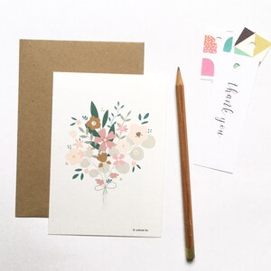 May include: A white card with a bouquet of pink, brown, and green flowers. The card has the text "thank you" on it.