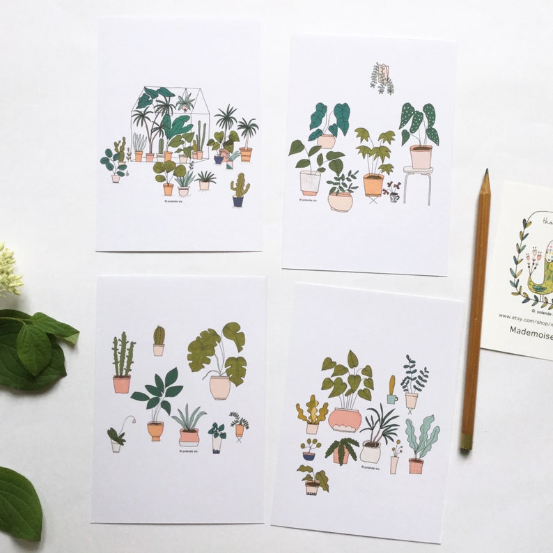 May include: Four printable cards featuring illustrations of potted plants. Each card has a different arrangement of plants, including cacti, ferns, and leafy plants. The cards are printed on white paper with black outlines and colorful accents.
