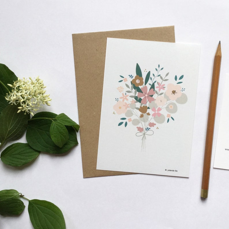 May include: A greeting card with a bouquet of pink, brown, and gray flowers with green leaves. The card has a white background and a brown envelope.