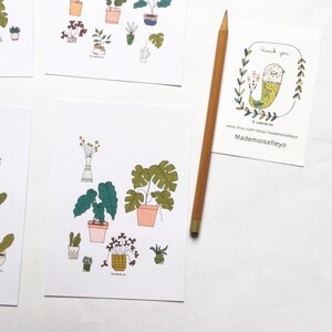 May include: A set of printable cards featuring illustrations of potted plants in various styles. The cards are white with black outlines and feature a variety of green plants in different pots. The cards are perfect for adding a touch of nature to your home decor.