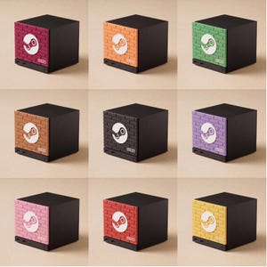 May include: A collection of nine black cubic storage boxes, each featuring a front panel with a textured brick pattern in various colours including magenta, orange, green, brown, black, purple, pink, red, and yellow, with a white Steam logo.