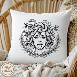 May include: White square pillow featuring a black and white illustration of Medusa with snakes for hair, a laurel wreath, and her tongue sticking out. The pillow has the text "GREAT FOR PILLOWS" in a circular design.
