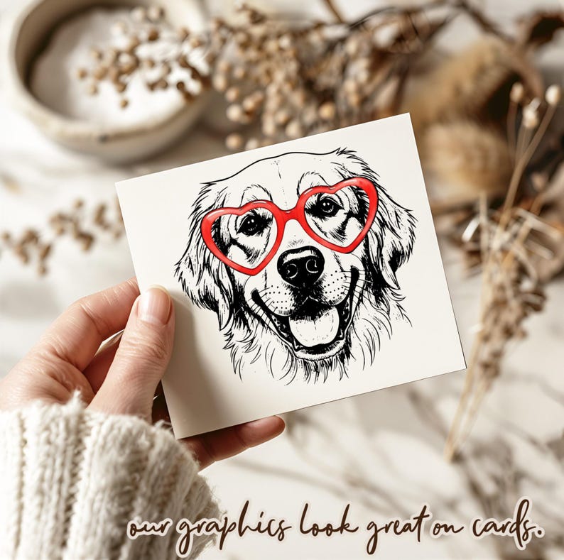 May include: A square card with a black and white illustration of a Golden Retriever wearing red heart-shaped glasses. The card has the text "our graphics look great on cards" in a handwritten style font.