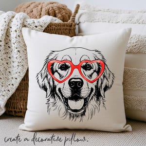 May include: A cream cushion with a black and white illustration of a Golden Retriever wearing red heart-shaped glasses. The cushion has the phrase "create a decorative pillow" printed at the bottom.