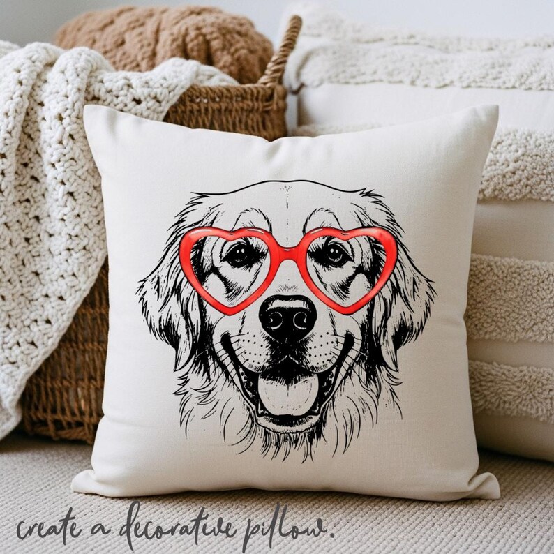May include: A cream cushion with a black and white illustration of a Golden Retriever wearing red heart-shaped glasses. The cushion has the phrase "create a decorative pillow" printed at the bottom.
