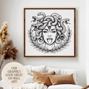 May include: Black and white Medusa art print in a brown wooden frame. The artwork features a detailed illustration of Medusa with snakes for hair, a laurel wreath, and her tongue sticking out. The text "OUR GRAPHICS LOOK GREAT ON WALL ART!" is in a circle in the lower left.
