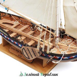 May include: A wooden model of a small sailboat with a white sail and a blue, red and white striped hull. The boat is on a wooden stand and has a label that reads "Seree Darya Type M-124".