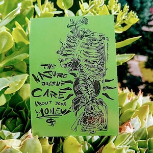 May include: A green sticker with black illustrations and text. The design features a human skeleton with plant elements and the words "THE NATURE DOESN'T CARE ABOUT YOUR MONEY" and a dollar sign.