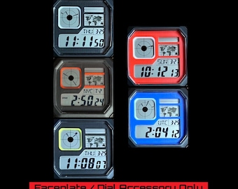 May include: A collection of square digital watch faceplates in various colors, including black, red, and blue. Each faceplate displays the time, date, and a world map graphic. The text "Faceplate / Dial Accessory Only Read Description" is at the bottom.