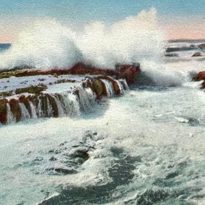 May include: Vintage postcard featuring a coastal scene. The image shows waves crashing against rocky cliffs, with the text "Rocky Coast, Laguna Beach, California" at the top. The sky is a light blue, and the water is a mix of white and blue.
