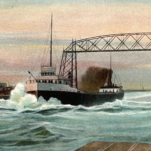 May include: Vintage postcard depicting the steamer E.J. Earling leaving Harbor, Duluth, Minn. The image shows a large ship sailing through choppy water, passing under a large bridge. The sky is a mix of pink and blue.