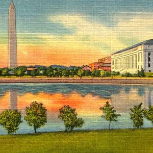 May include: Vintage postcard featuring the New Bureau of Printing and Engraving on Potomac Park and Basin in Washington, D.C. The image shows the Washington Monument, a large building, and their reflections in the water. The sky is a mix of orange, blue, and yellow.
