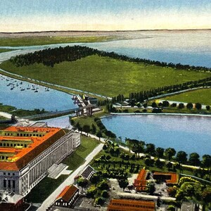 May include: An aerial view postcard of Washington Harbor and the Potomac River in Washington, D.C. The postcard shows a large building with a red roof and a bridge in the distance. The text on the postcard reads "M507: WASHINGTON HARBOR AND POTOMAC RIVER, SOUTH FROM MONUMENT, WASHINGTON, D. C."