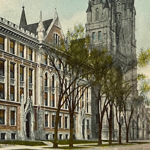 May include: Vintage postcard featuring Marquette University and Gesu Church in Milwaukee. The image showcases a multi-story brick building with numerous windows and a tall, ornate church tower. Trees line the street in front of the buildings.