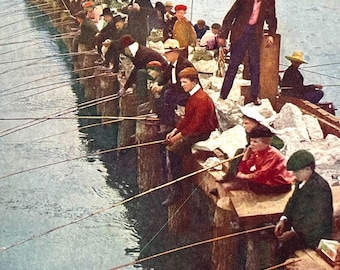 Op de afbeelding: Een vintage ansichtkaart met de titel VACATION DAYS, CHICAGO, No. 1392, V. O. Hammon Pub. Co., Chicago, met een lange houten pier die in het water uitsteekt. Talrijke personen met hoeden en jassen staan langs de rand te vissen met lange hengels.