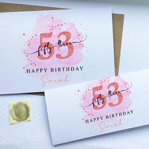 May include: Pink watercolour birthday card with the number 53 in glitter and the text "fifty-three" and "Happy Birthday Sarah".
