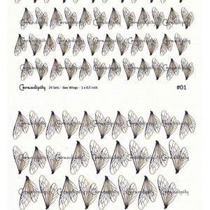 May include: A sheet of bee wing decals in various sizes. The wings are black and gold, with intricate vein details. The text "Cerandipity" and "24 Sets - Bee Wings - 2.5 x 1.3 cm" are visible. The image also includes the text "#01".