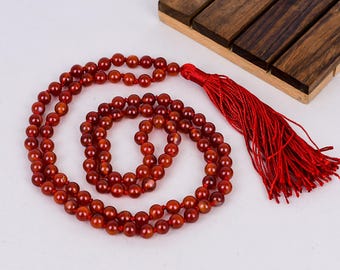 Collar Japa Mala de ónix rojo con 108 cuentas de 6 mm, anudado a mano y borla roja.