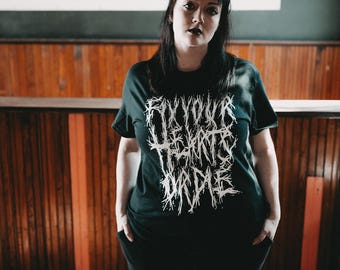 May include: A black t-shirt with a white graphic print that reads "Fix Your Heart Or Die".