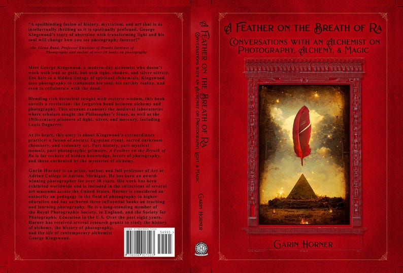 May include: Book cover for "A Feather on the Breath of Ra: Conversations with an Alchemist on Photography, Alchemy, & Magic." The red cover features a central image of a red feather floating above a pyramid.