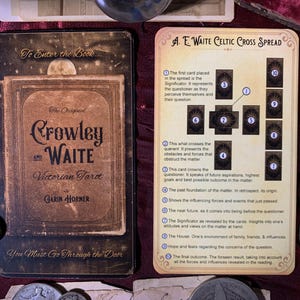 May include: A vintage tarot card deck box with the text "The Original Crowley and Waite Victorian Tarot" and "To Enter the Book... You Must Go Through the Door". The box is brown with gold lettering and a moon and stars design. The box is open and shows a card spread with instructions for a Celtic Cross spread.