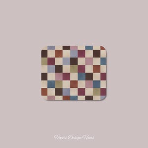 May include: A rectangular coaster featuring a multi-colored checkerboard pattern with squares in shades of cream, dark brown, muted red, dusty blue, olive green, and mauve. The text Hope's Design Haus is printed in white script below the coaster.