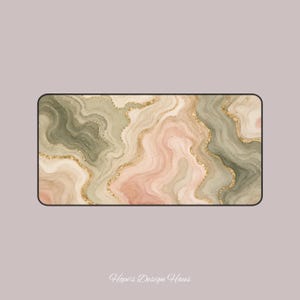 May include: Rectangular decorative mat with a watercolor design. The mat features a swirling pattern in shades of green, pink, and beige, accented with gold glitter lines. The text "Hope's Design Haus" is at the bottom.