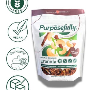 May include: A white bag of "Purposefully" original cinnamon granola, with a cashew and cinnamon illustration. The bag is labeled "Gluten Free", "Vegan", "Gut Healthy", and "Low Sugar". Net weight is 227g.