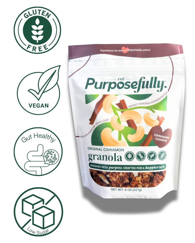 May include: A white bag of "Purposefully" original cinnamon granola, with a cashew and cinnamon illustration. The bag is labeled "Gluten Free", "Vegan", "Gut Healthy", and "Low Sugar". Net weight is 227g.