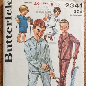 May include: A vintage sewing pattern for boys' pajamas. The pattern includes three different styles: a striped pajama set, a plaid pajama set, and a short-sleeved shirt and shorts set. The pattern is for chest size 26 and size 8. The pattern is from Butterick and costs 50 cents.