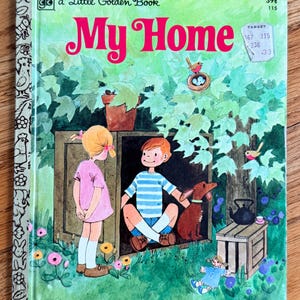 May include: A Little Golden Book titled My Home featuring a colorful illustration of a girl in a pink dress and a boy in a blue striped shirt sitting in a wooden structure with a brown dog, a bird in a nest, and a small doll on the grass.