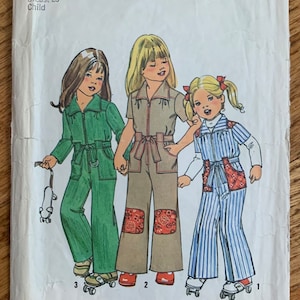 May include: A Simplicity sewing pattern for children's clothing, pattern number 7277. The pattern shows three girls wearing different styles of jumpsuits, all with long pants and a zipper down the front. The girls are wearing roller skates and are holding a skateboard. The pattern is for size 6, with a 25 inch bust.