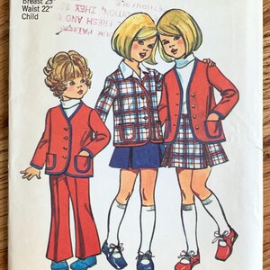 May include: Vintage Simplicity sewing pattern number 5278 for children's clothing. The pattern includes three outfits: a red jacket and pants, a plaid jacket and skirt, and a red jacket and plaid skirt. The pattern is for size 6, with a 25 inch bust and 22 inch waist. The pattern is dated 1/74.