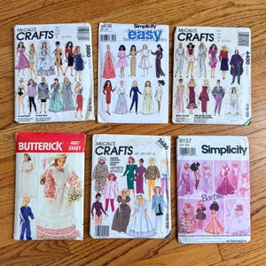 May include: Six vintage sewing pattern envelopes featuring illustrations of dolls and fashion designs. Brands include McCall's Crafts, Simplicity, and Butterick. The patterns showcase various styles, from formal gowns to casual wear, with a focus on doll clothing.