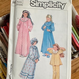 May include: Simplicity sewing pattern number 7646 for girls' sleepwear. The pattern includes three different styles: a pink nightgown with a ruffled collar, a blue nightgown with a ruffled collar, and a yellow pajama set with a ruffled collar. The pattern is for medium size.