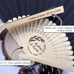 May include: A personalized wooden fan with laser-cut floral details. The fan features custom text, including names and dates, ideal for weddings or special events. The fan is made of light-colored wood and has a dark background.
