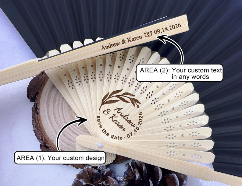 May include: A personalized wooden fan with laser-cut floral details. The fan features custom text, including names and dates, ideal for weddings or special events. The fan is made of light-colored wood and has a dark background.