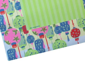 May include: A colorful patterned fabric featuring hanging lanterns in pink, blue, and green against a light yellow background. The top right corner has a section with green vertical stripes. The text "MAHJONG" is visible.