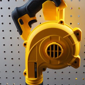 May include: A yellow and black cordless leaf blower. The blower has a black handle and a yellow body with a round air outlet. The product has the text "20V MAX" printed on the side.